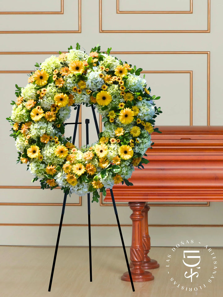 Corona de Condolencias Luz Eterna arreglo de condolencias con 12 gerberas amarillas + margaritas