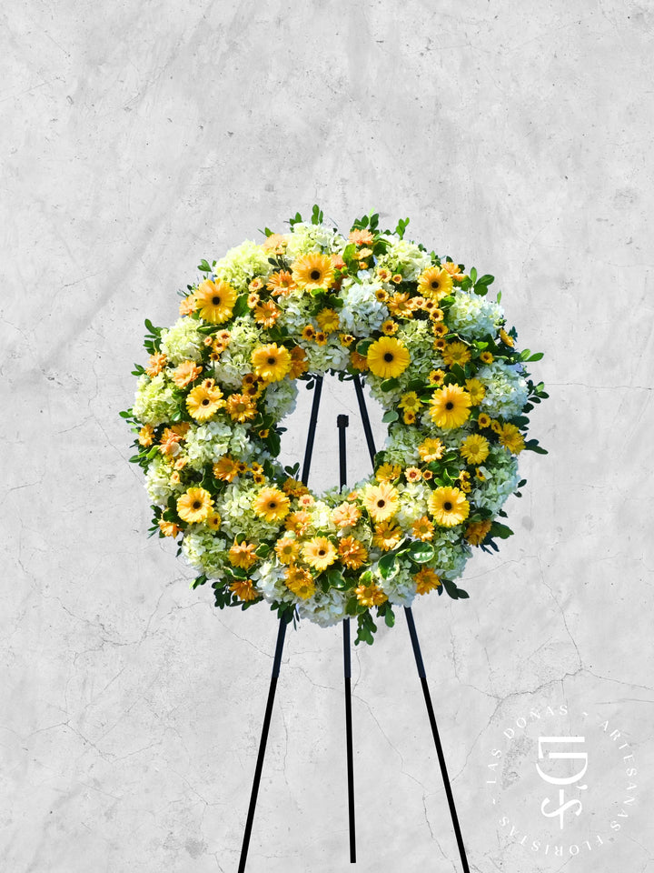 Corona de Condolencias Luz Eterna arreglo de condolencias con 12 gerberas amarillas + margaritas