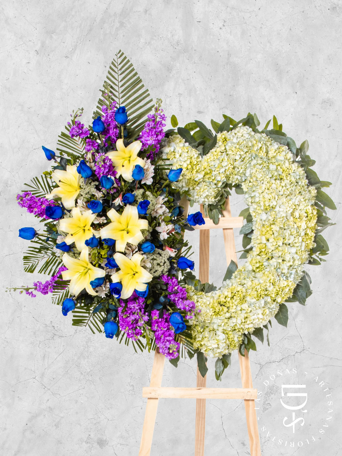Corona de Corazón con Hortensias, Rosas Azules y Liliums arreglo de condolencias con 24 rosas azules